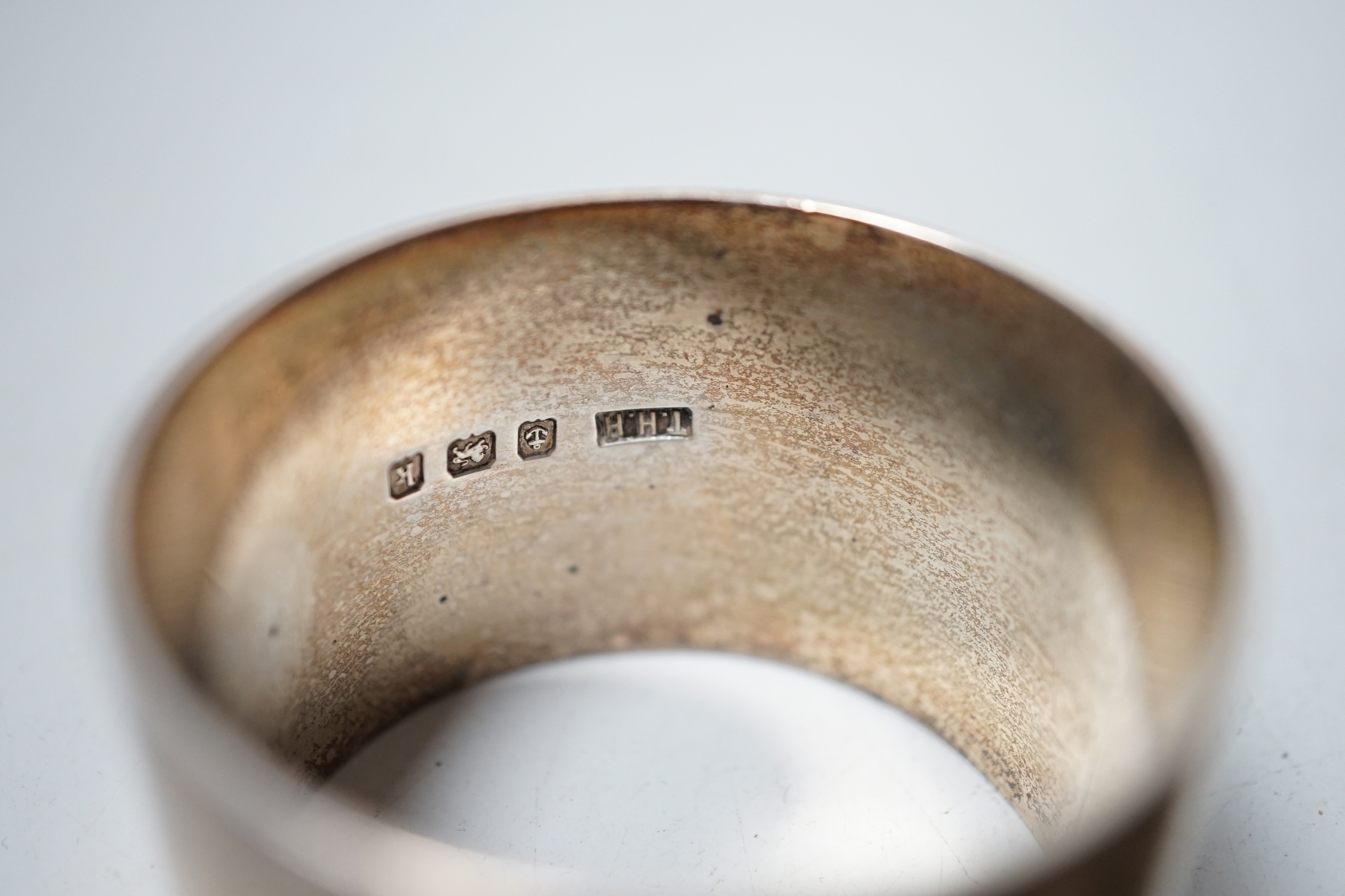 Five assorted silver napkin rings.